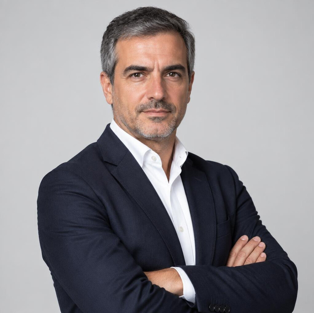 Studio portrait of a middle-aged Portuguese male journalist in a shirt and blazer